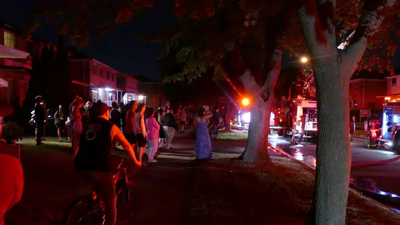 People observe curiously after a fire incident in a house