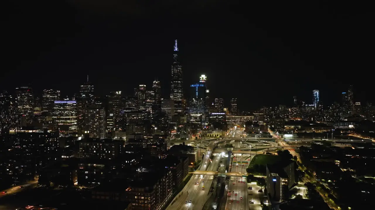 Aerial tracking shot over the West loop and the illuminated Chicago skyline in Il USA