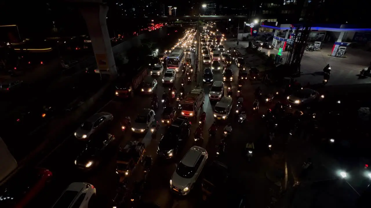 An aerial shot of night traffic cars on highway road at night in busy city