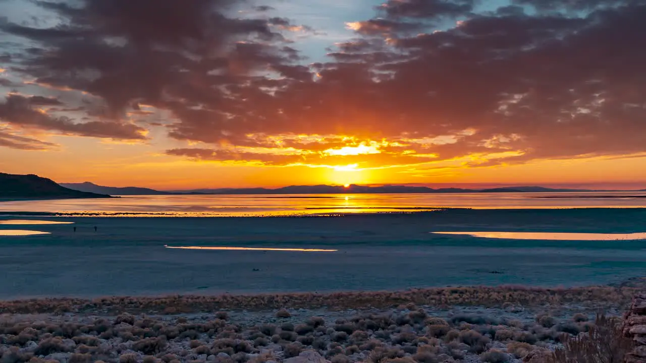 The sun sets beyond the shore of Antelope Island in Central Utah panning time lapse of the Great Salt Lake