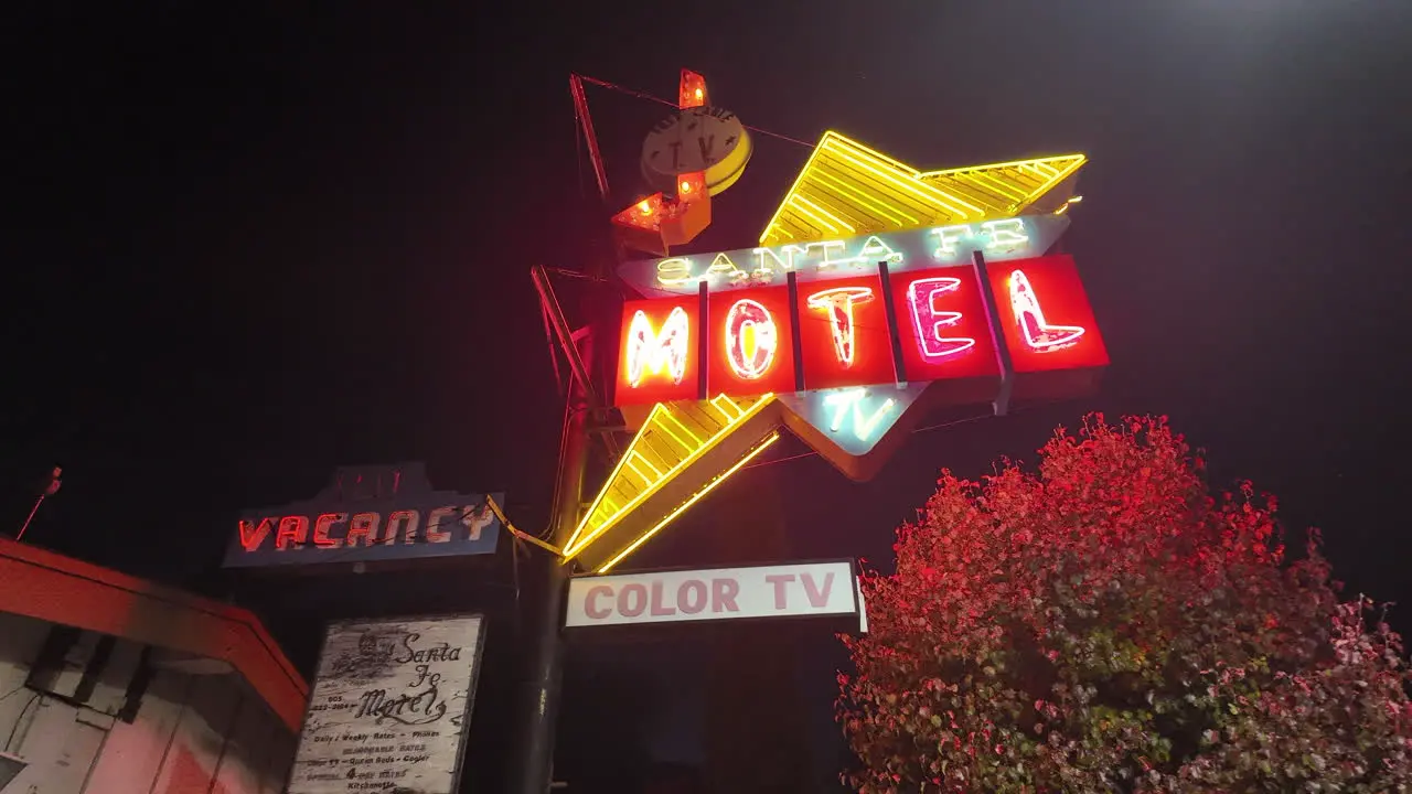 Bright nostalgic neon sign for the Santa Fe Motel in Tehachapi California at nighttime