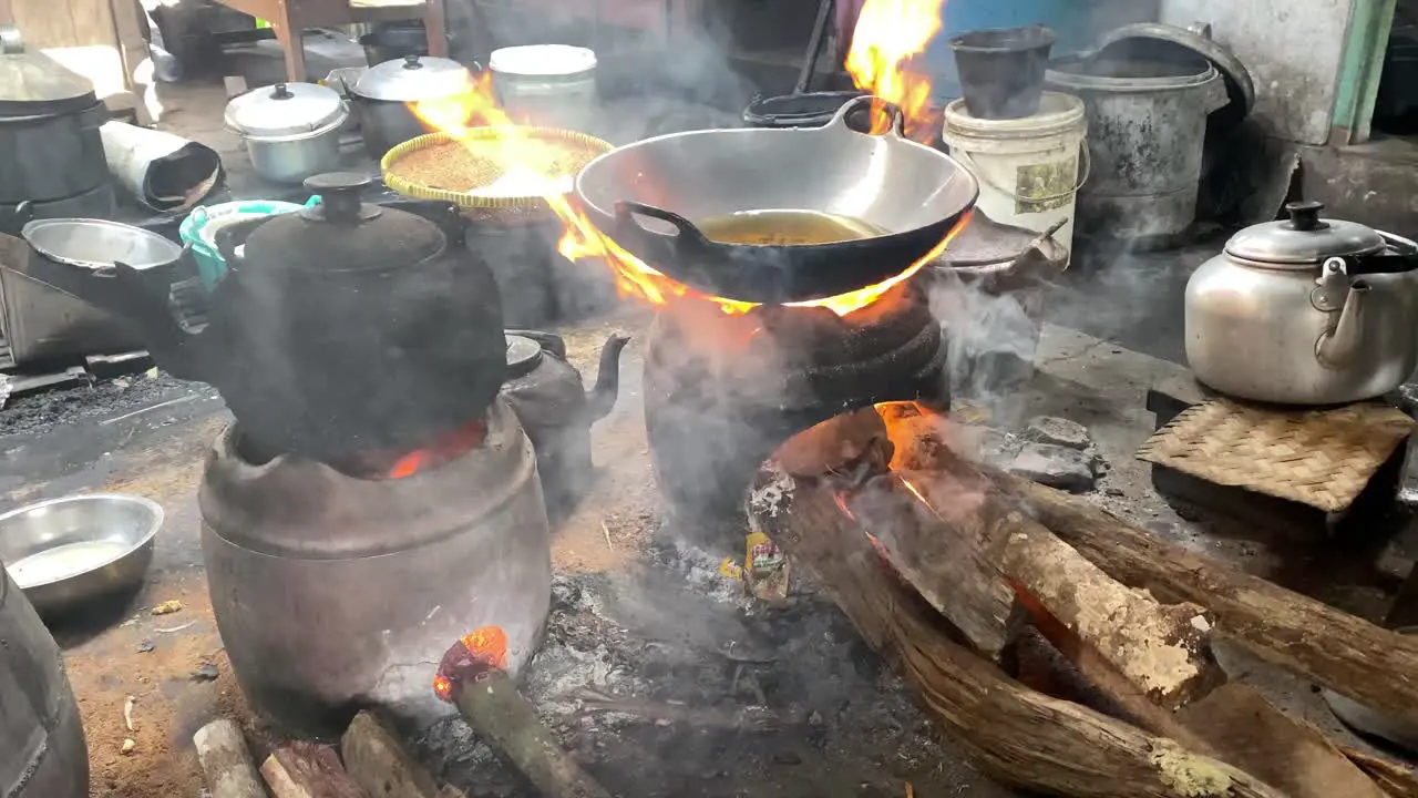 The process of cooking fried foods such as tofu tempeh in a traditional skillet and stove using coals and a stove-1