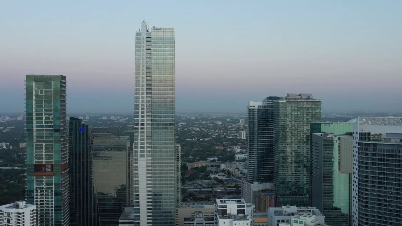 Late evening aerial view descending away from Miami skyscrapers cityscape horizon