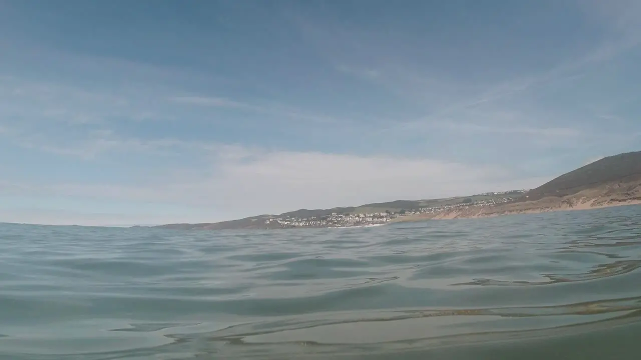 View from Sea of Small Seaside Resort Town from Calm Ocean Beach