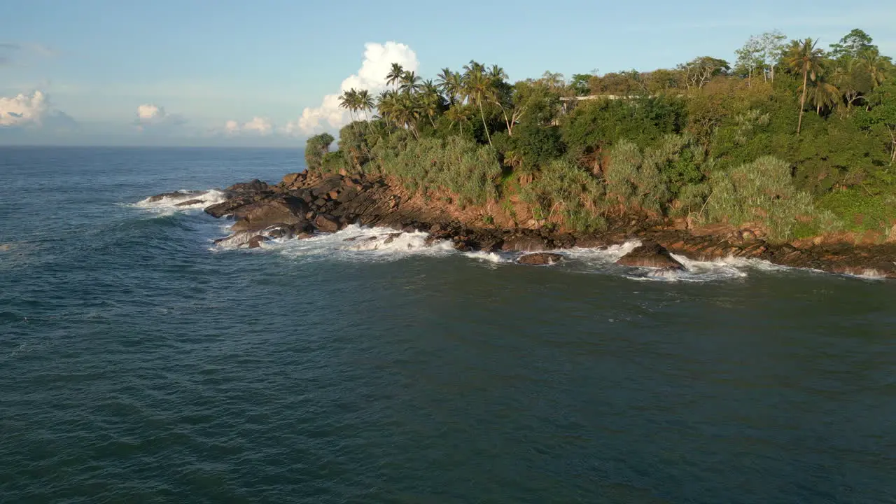 Rising Establishing Aerial Drone Shot of Waves Crashing Against Rocky Tropical Coastline in Southern Sri Lanka