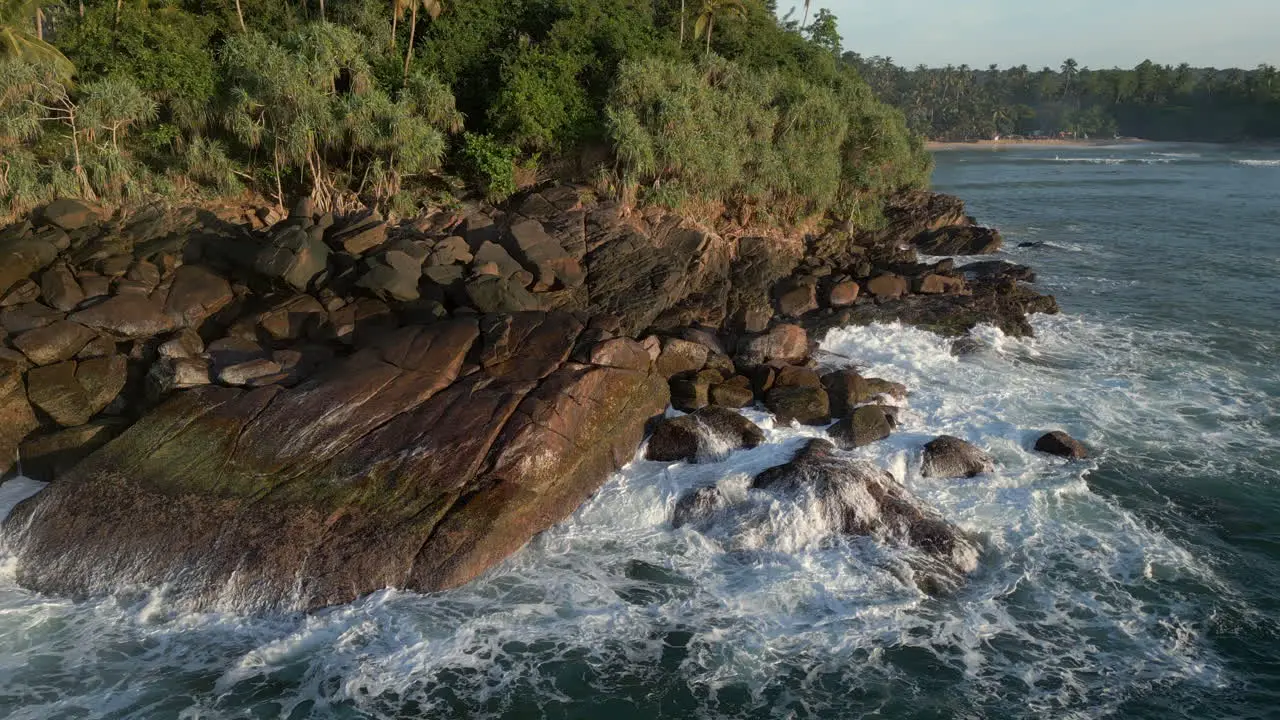 Low Aerial Drone Shot of Waves Crashing into Rocky Shoreline in Tropical Sri Lankan Southern Coast