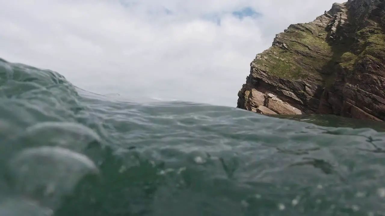 Rocky Coastal Landscape on Beach as Camera Floats and Dips Underwater