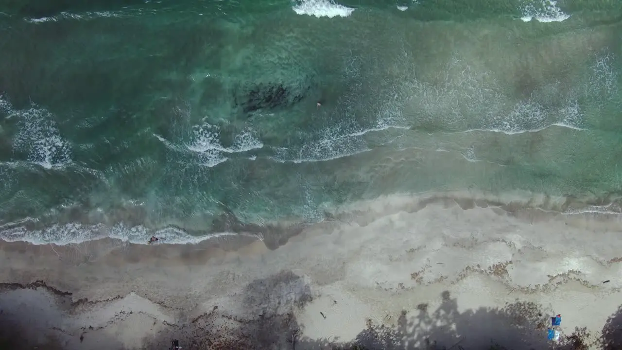 Birdseye Drone Aerial Over Blue Ocean Waves Onto Sand At Cahuita Beach Costa Rica 4K