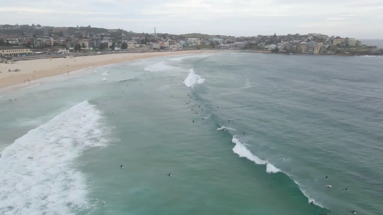 Splashing Waves With Tourists In Bondi Beach With Urban Landscape In Background At Eastern Suburbs Sydney New South Wales Australia