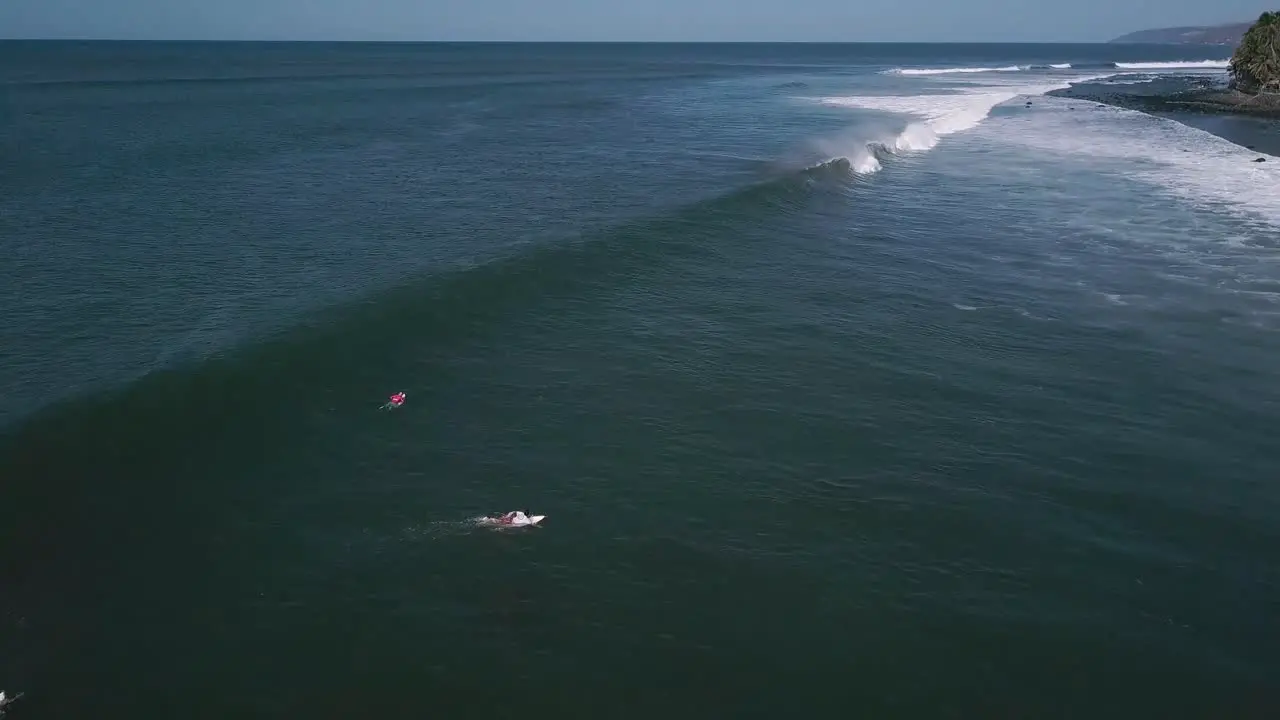 Surfers attempt to ride large waves in the shores of the Cocal Beach in La Libertad El Salvador