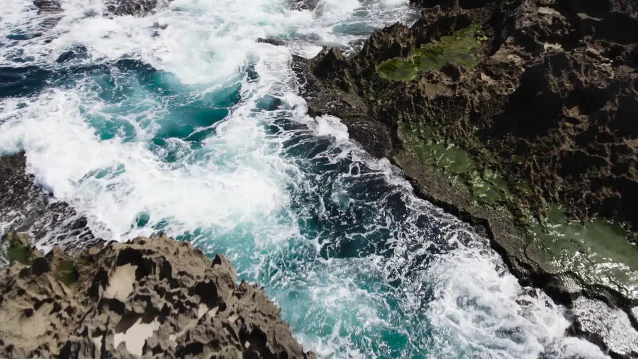 Puerto Rico fast push in shot over person and splashing waves against rocks