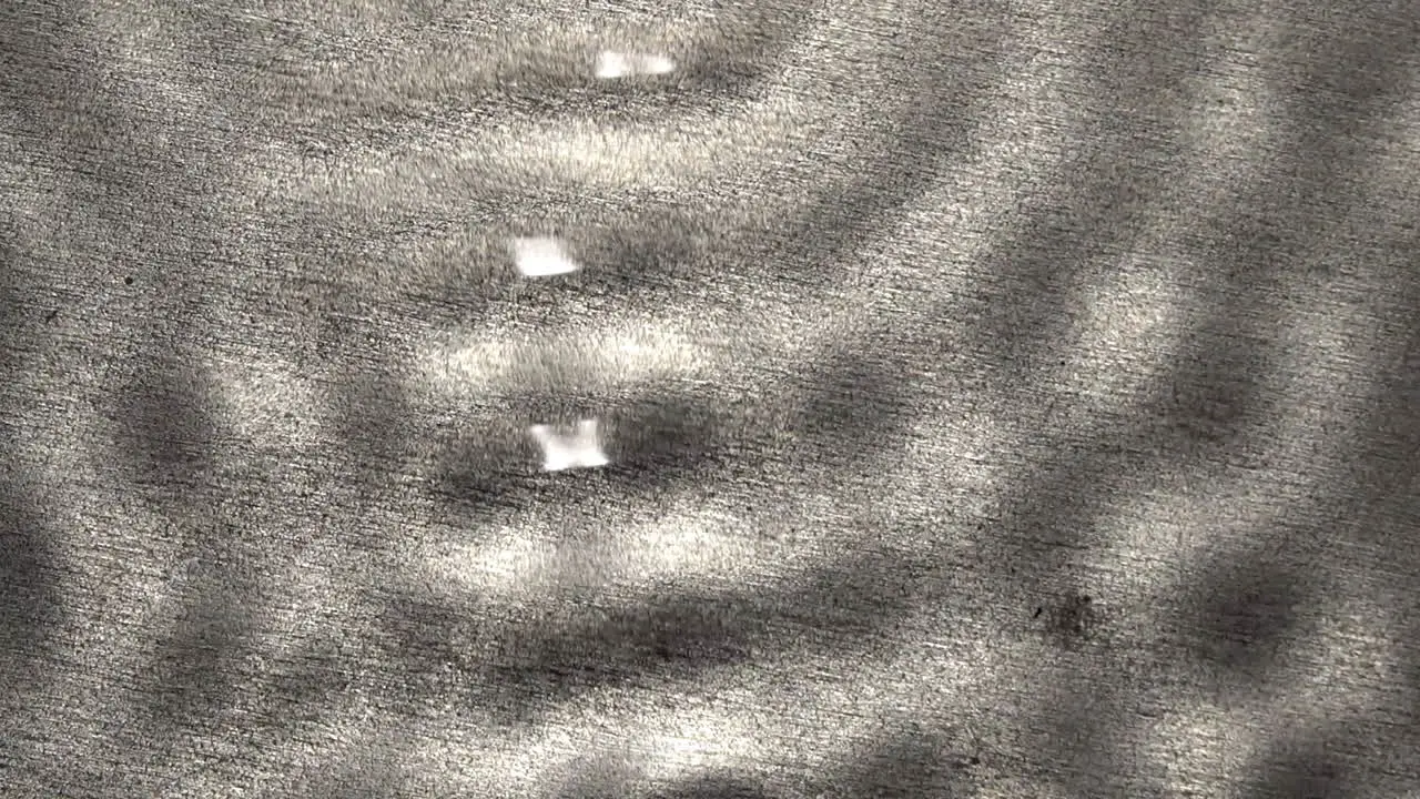 Rapid sequence of overlapping wave forms with asemic figures and a levitating droplet