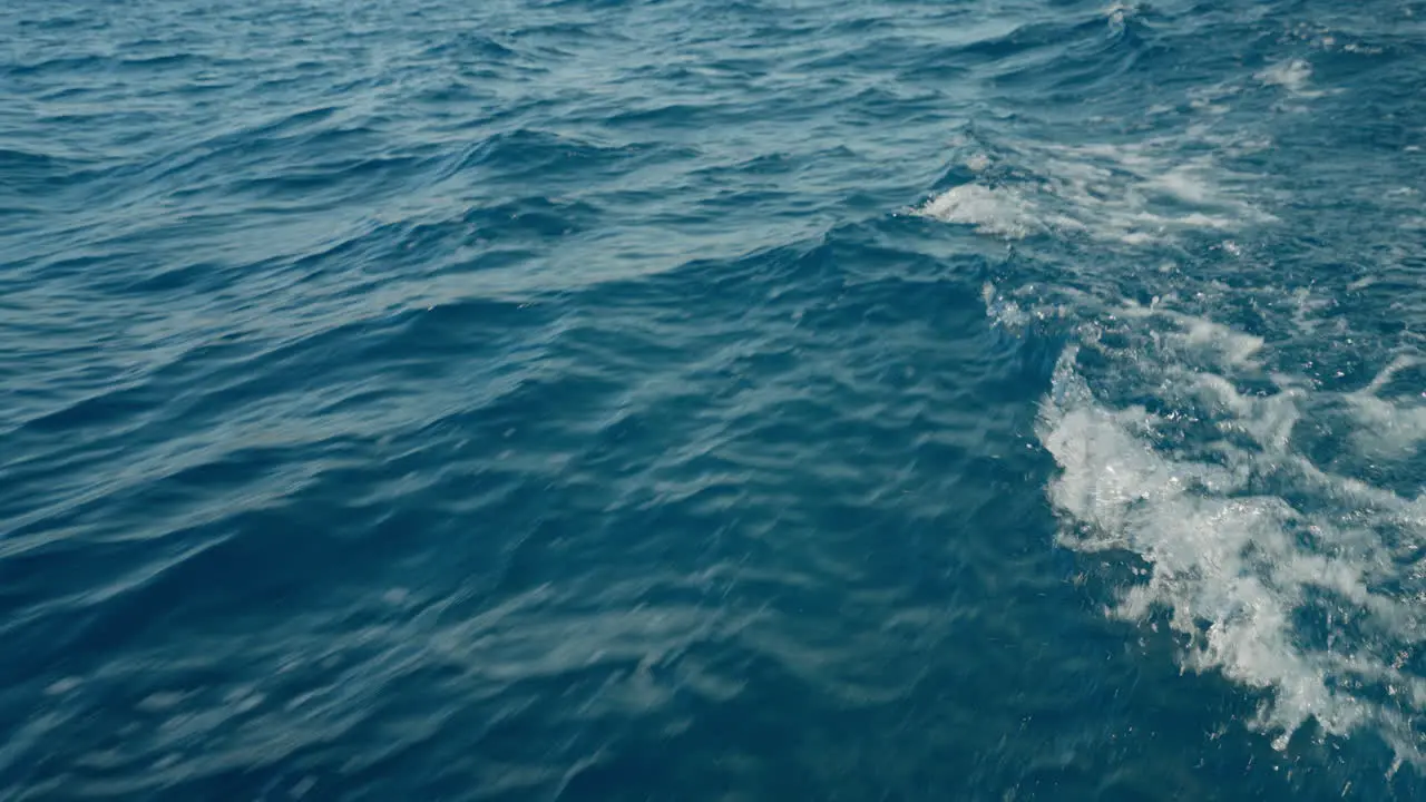 Beautiful blue waves caused by a boat