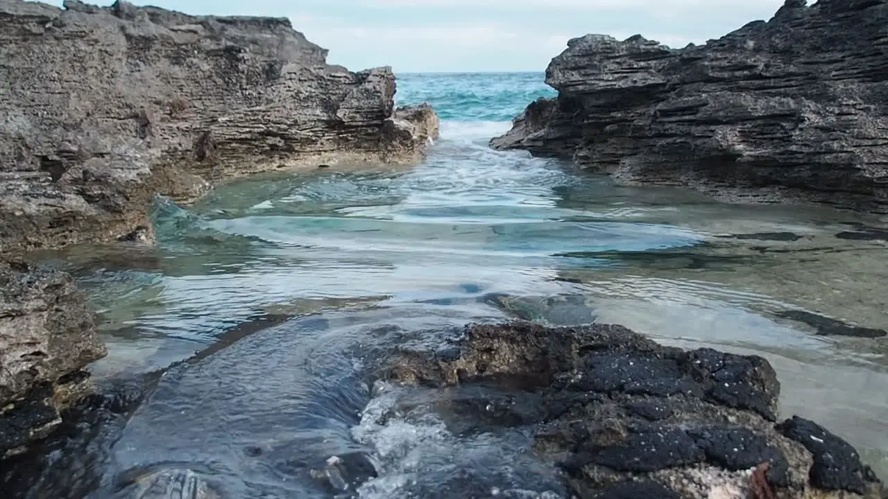 Blue water crashing on the rocks