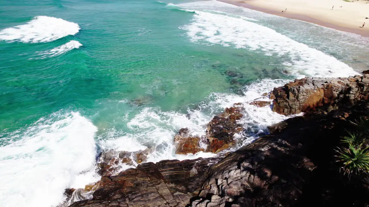 Pullback Over Rocky Cliffs With Crashing Waves In Noosa National Park QLD Australia