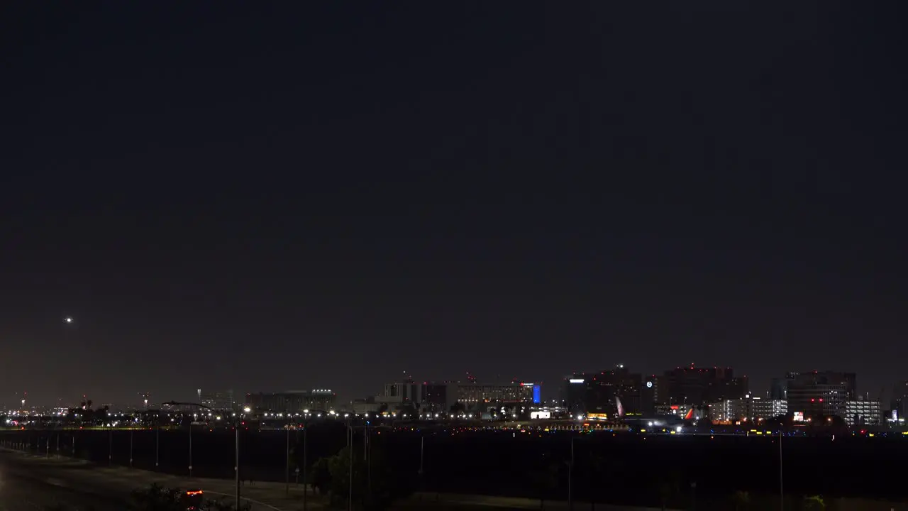 lax airport at night with flights taking off and landing