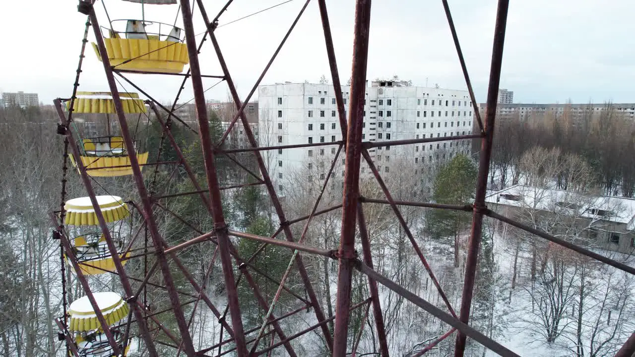 Rusty Ferris wheel above winter Pripyat in Chernobyl exclusion zone