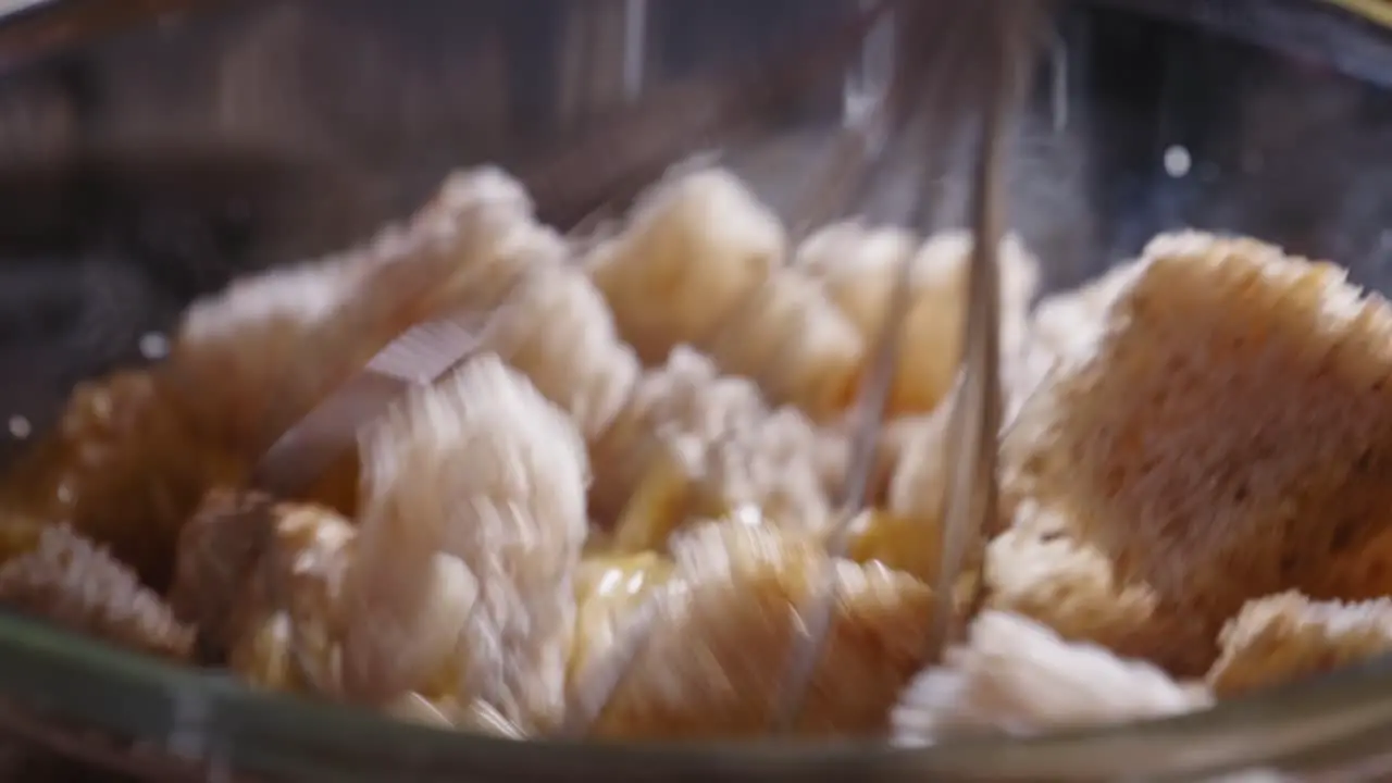 Mixing Bread Cubes And Fresh Eggs In A Bowl Using Whisk