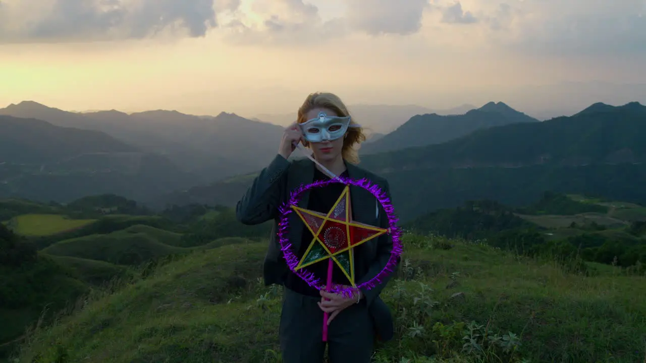 Slow motion shot of a woman putting on a mask and holding a star lantern