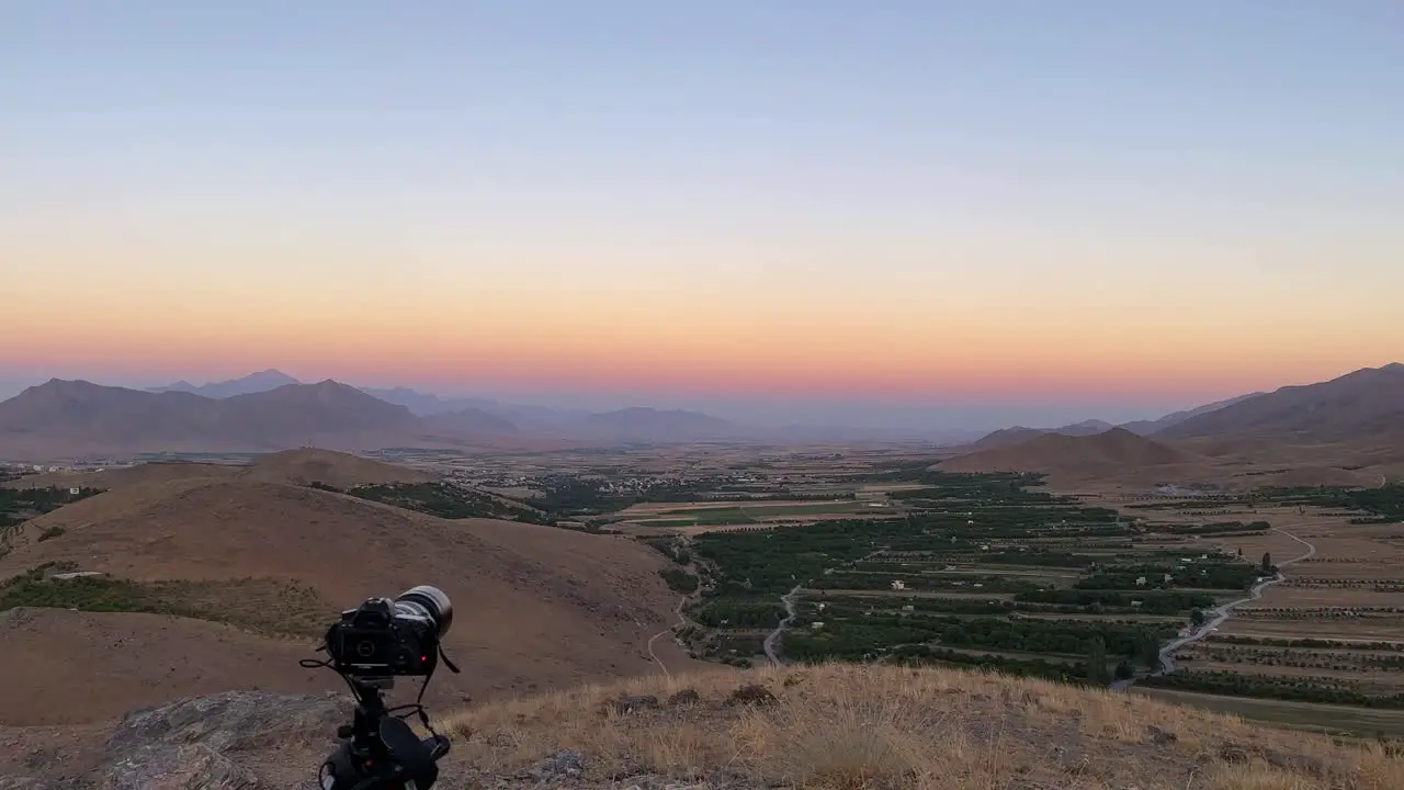 Photography experience in mountain highland panoramic landscape view of wide horizon blue sky line in mountain region in Esfahan the garden orchard field green hay bale fruit tree a colorful twilight