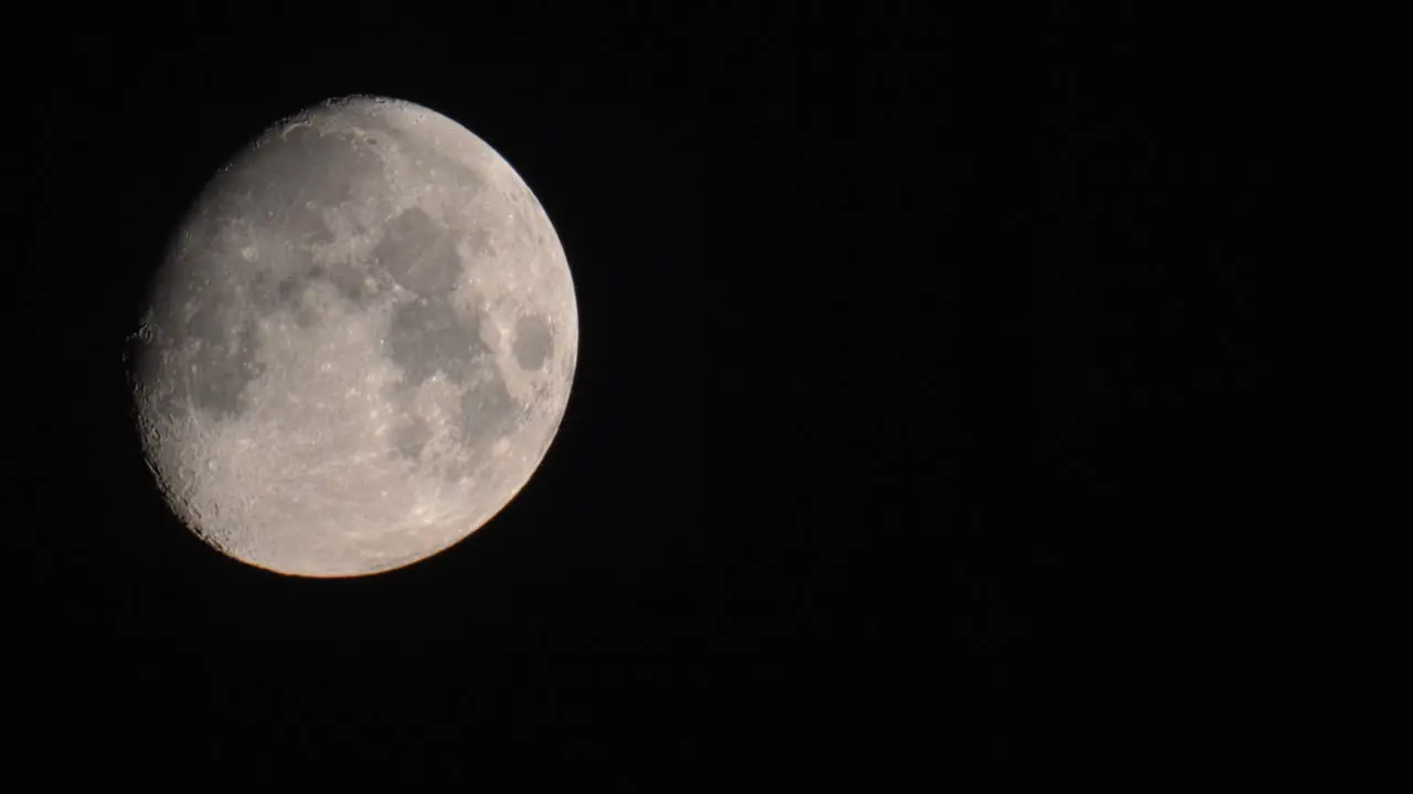 Close up Moon moving across the frame