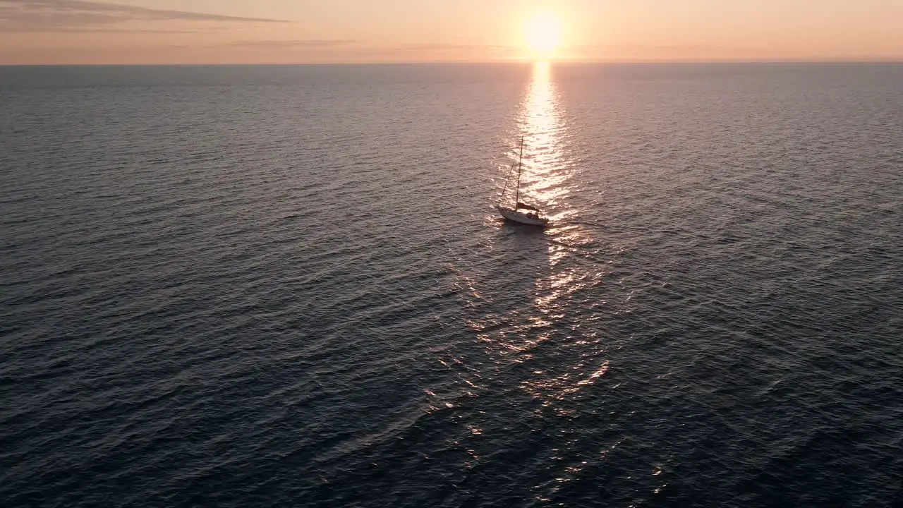 A Lone Sailboat Cruising On The Open Waters Of Saint Lawrence With A Scenic View Of Sky On A Sunrise In Quebec Canada