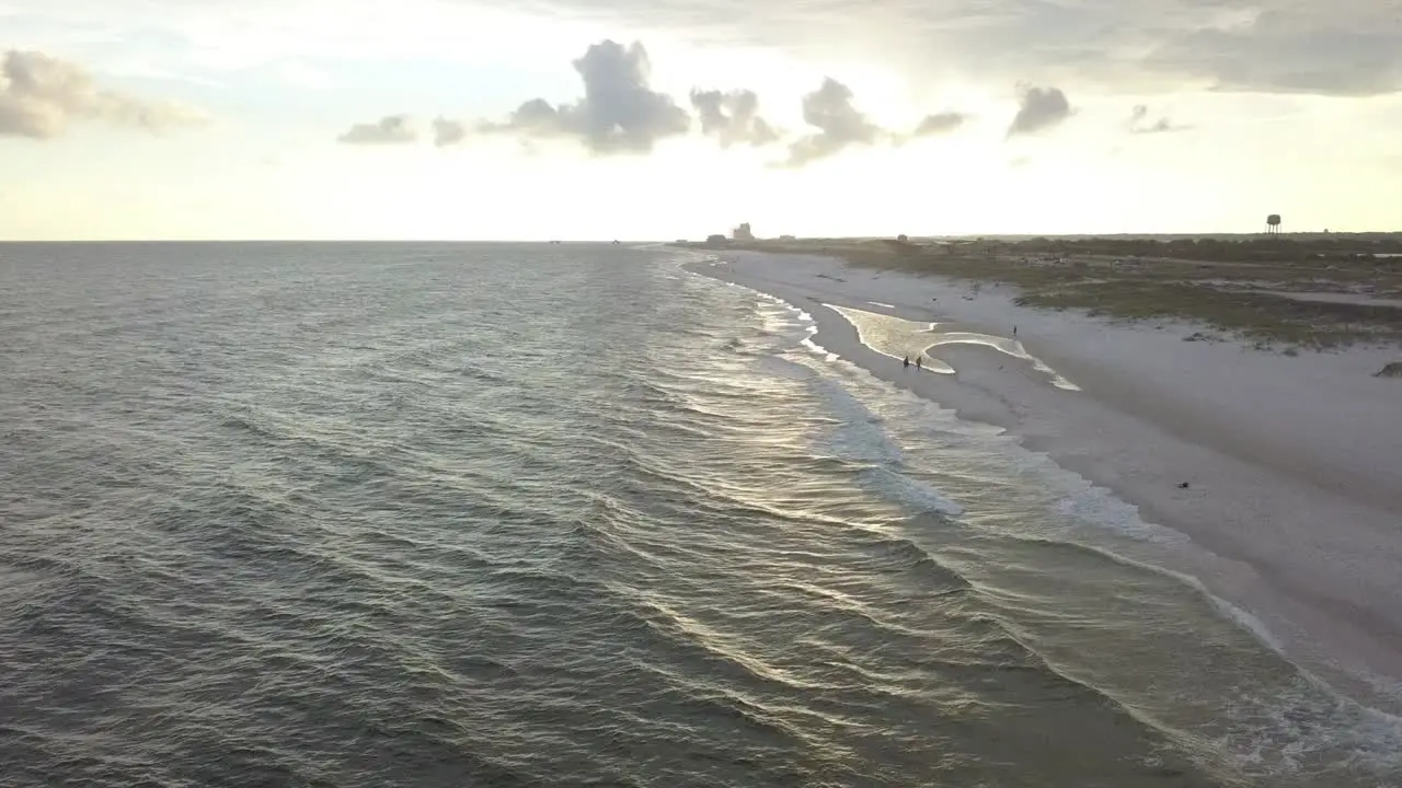 Beautiful Long Stretch Of Sandy Beach At Sunset aerial drone shot