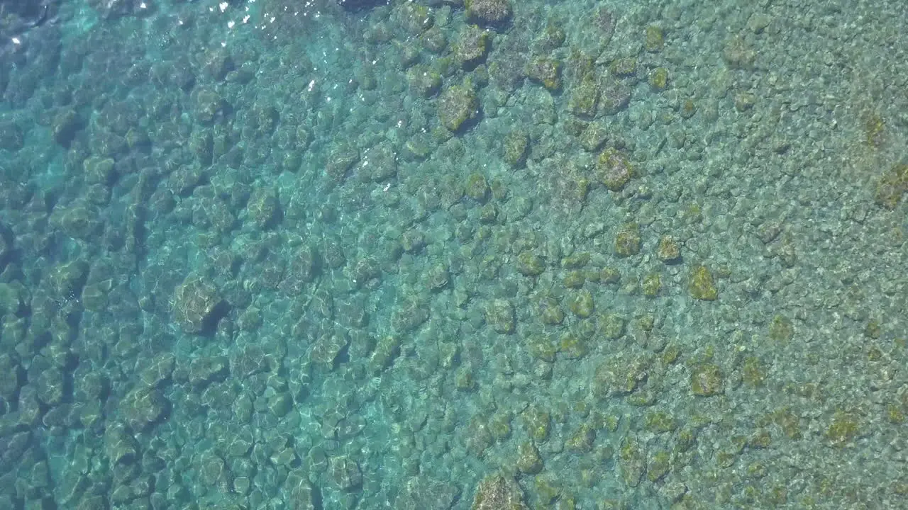 Calm waves transparent clear sea water at summer tropical beach aerial view