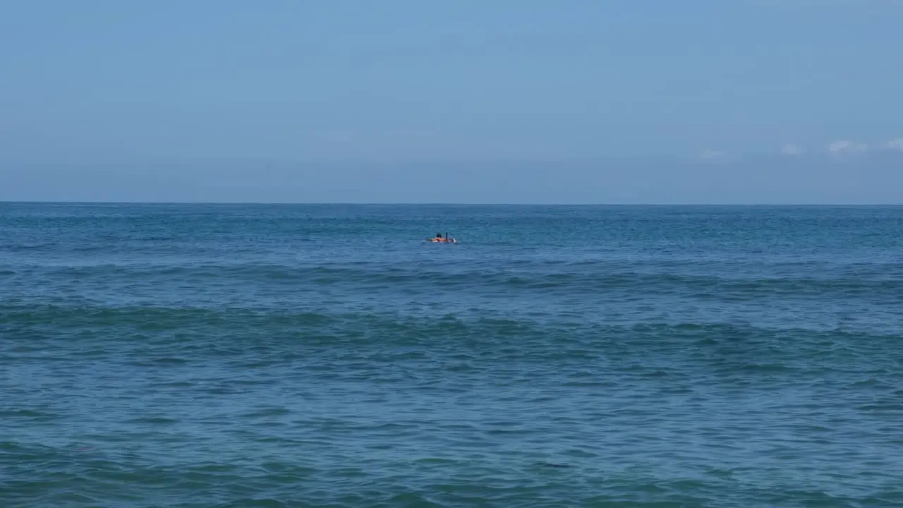 Seascape Scenery With Lone Surfer Swimming On A Surfboard At Summer