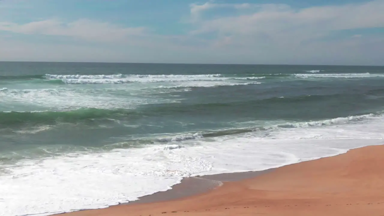 Sandy beach with ocean waves breaking on shoreline Soustons in France