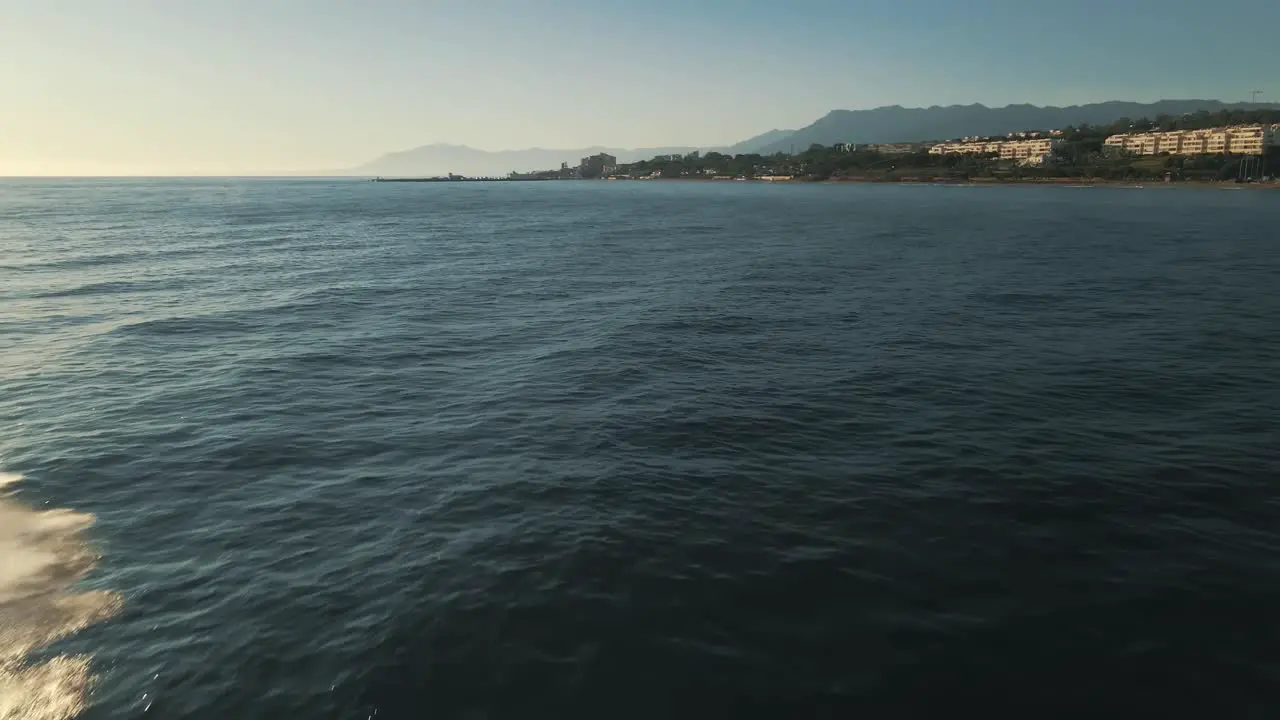 Fast aerial view of ocean waves with jetskier passing by