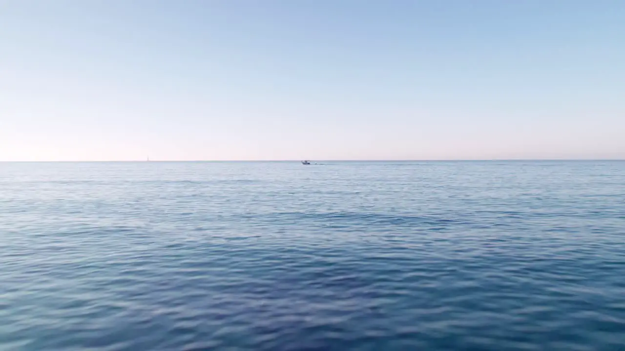 Drone flying fast and low over the calm Mediterranean sea