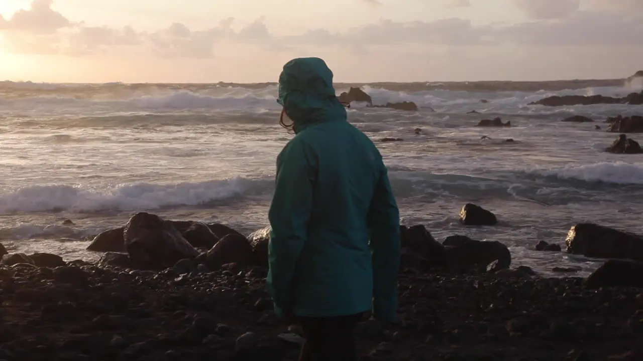 Free woman strolling on rocky shores of Azores Portugal