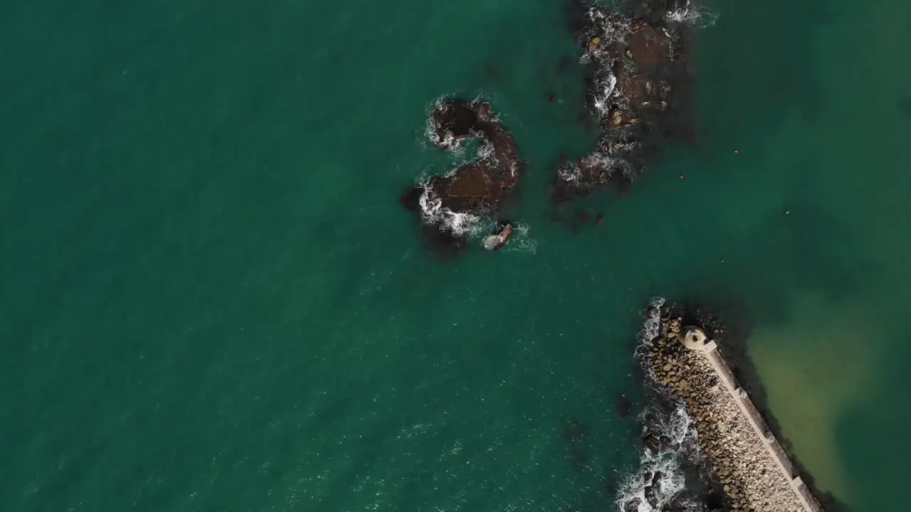 Aerial view above a grounded ship on skerries in Tel aviv Israel top down drone shot