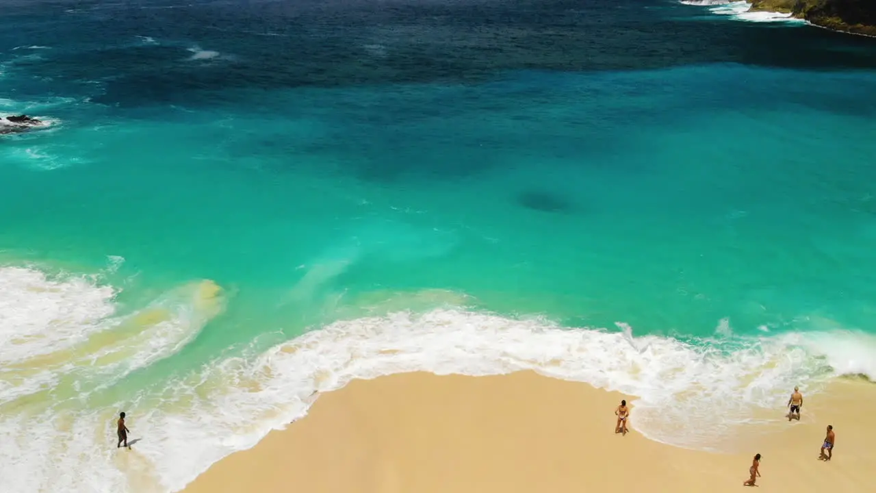 Tourists enjoying the waves of a turquoise ocean