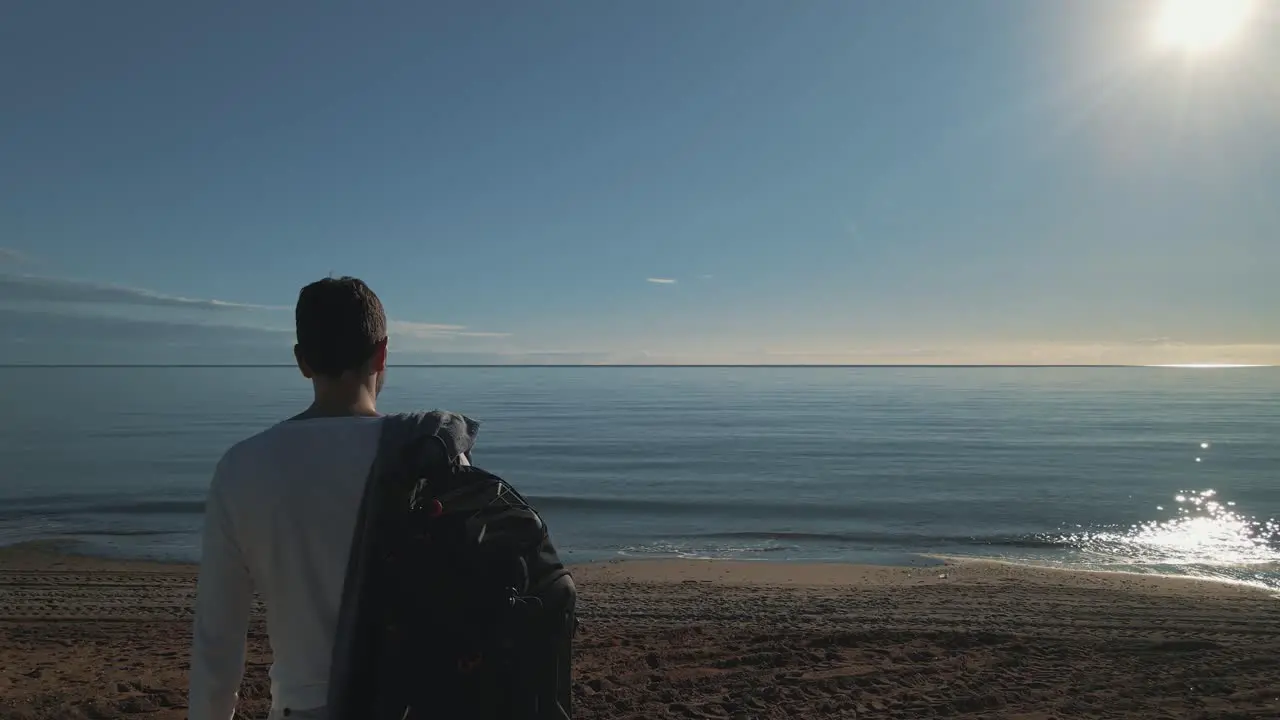 Man staring at the beach short dolly movement forward