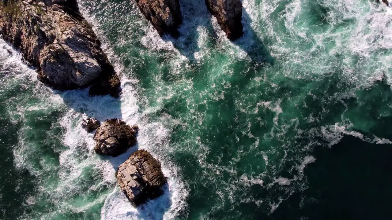 Birds Eye Top Down View of Natural ocean waves and rock cliff formation Mother Earth environmental concept