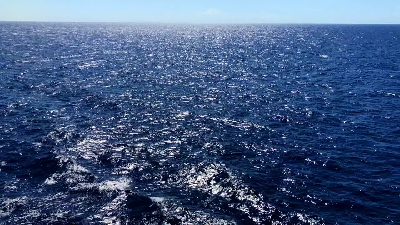 Caribbean waters roll past with its deep blue color