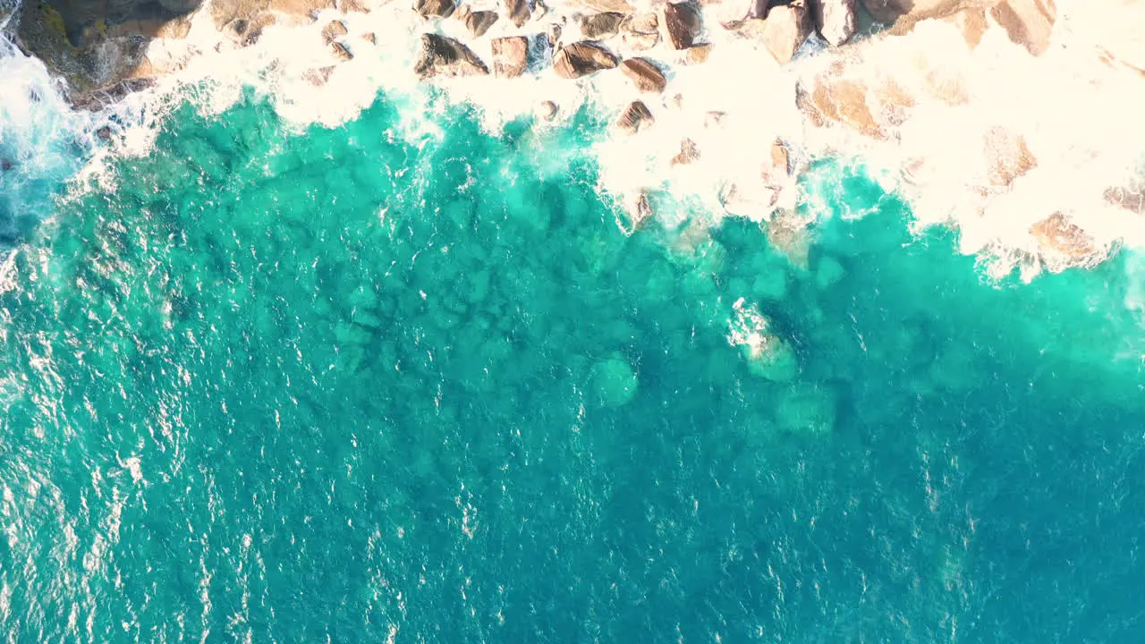 Aerial shot of ocean coast with views of waves and cliffs