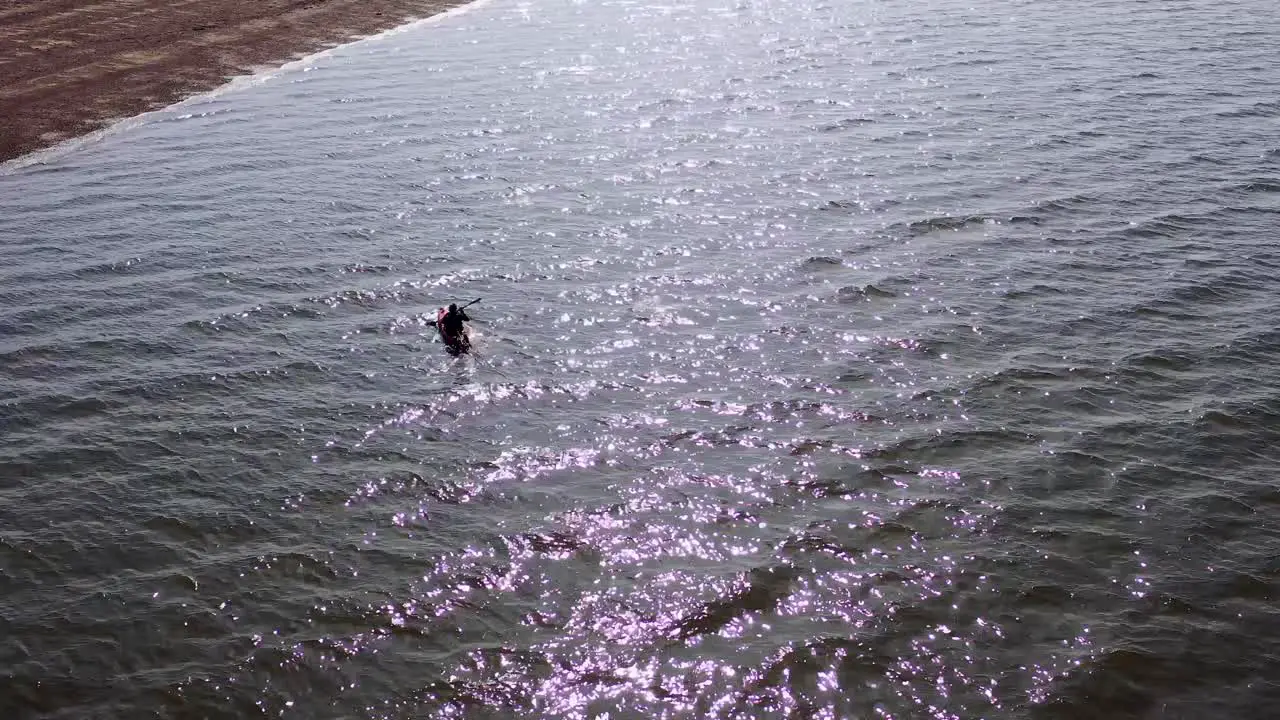 Aerial view of a single Kayak in reflected light on the sea at Hunstanton UK