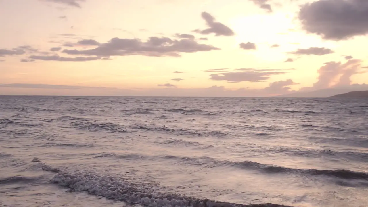 Pan across beach during a beautiful sunset on the coast of Maui Hawaii