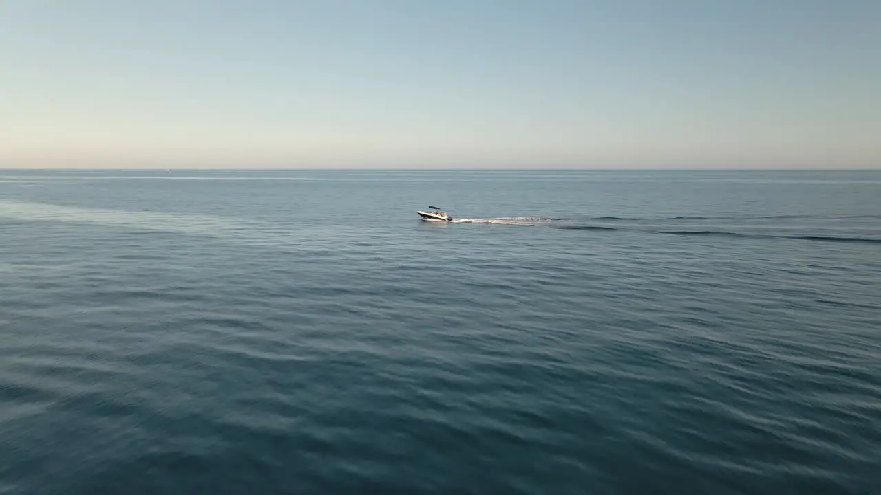 Single boat cruising across aerial view Spanish ocean seascape water surface