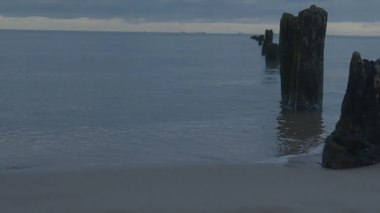 Calm Sea With Old Wooden Pole Heads At Dawn In Górki Zachodnie Gdańsk Poland