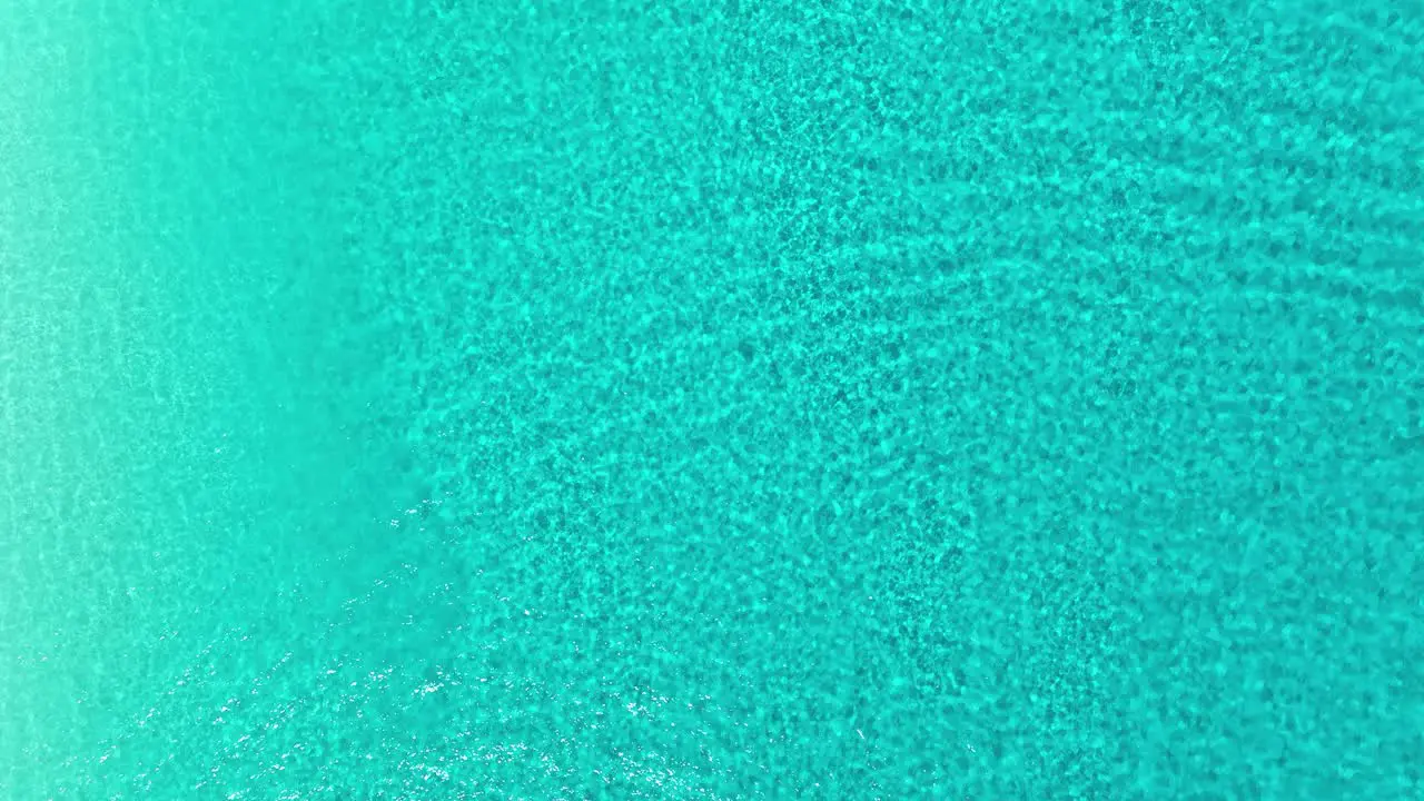 Aerial view above shallow turquoise waters of Cancun Mexico cenital drone shot