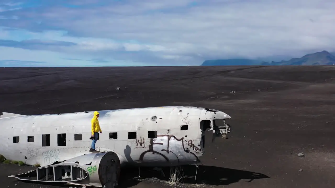 person walking on a plane wreck in iceland