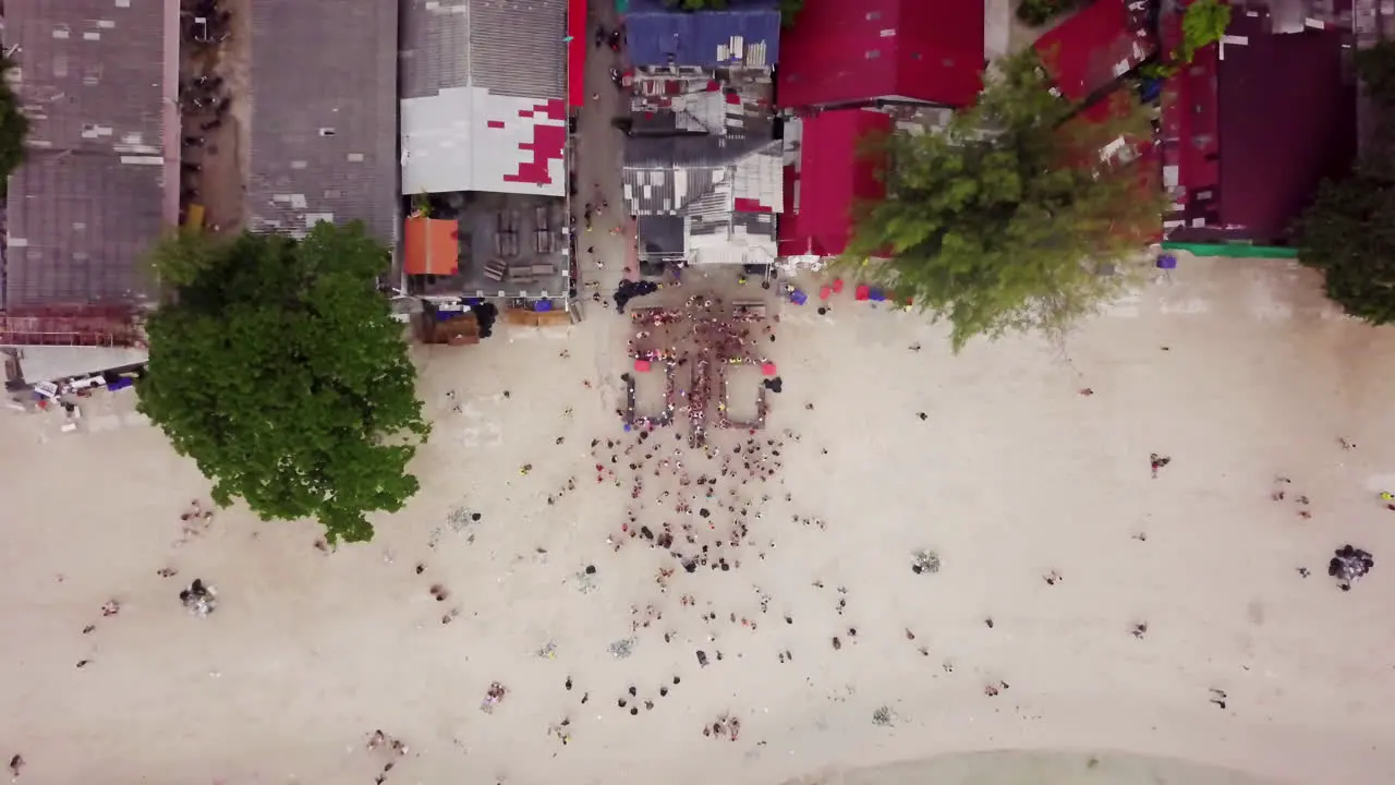 Aerial Top Down Shot of Young Adults at the Beach After The Full Moon Party in Koh Phangan Thailand