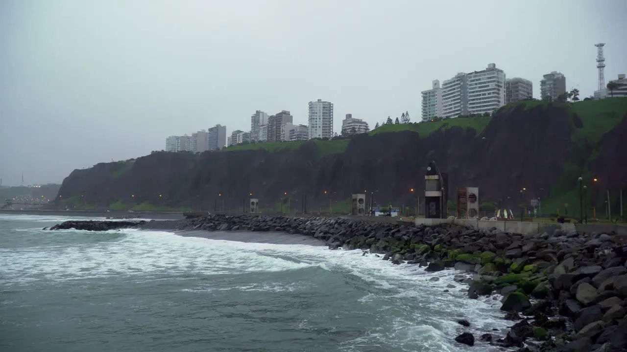 Static shot of a foggy morning at a rocky beach in Tres Picos Malecon de Miraflores Lima Peru