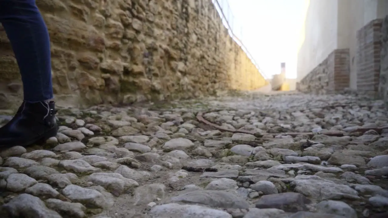 Slow Motion Shot Of Person's Feet Walking On Pebble Ground In roman Rural Street