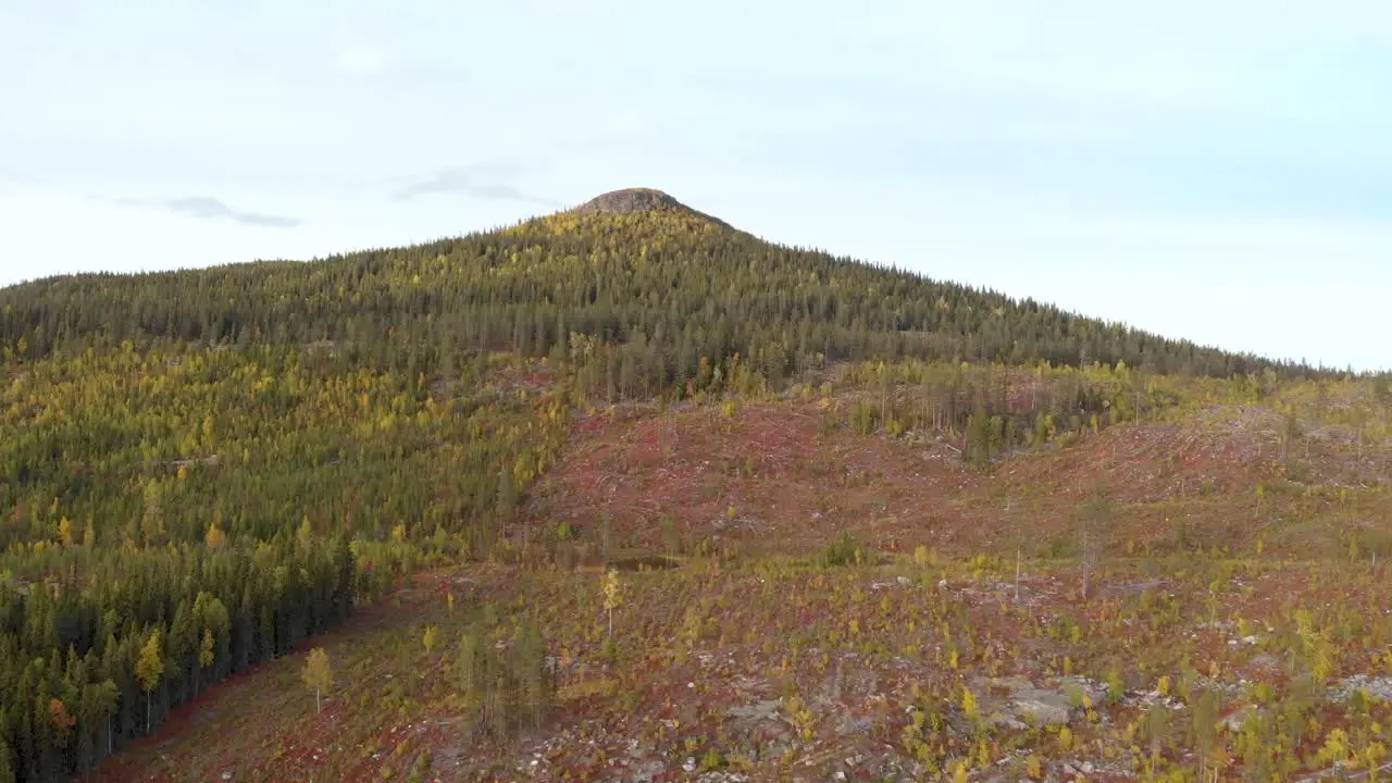 Slow aerial crane shot of rocky Scandinavian Mountain peak devoid of trees and forestation with a barren and sterile surrounding in Lapland Sweden