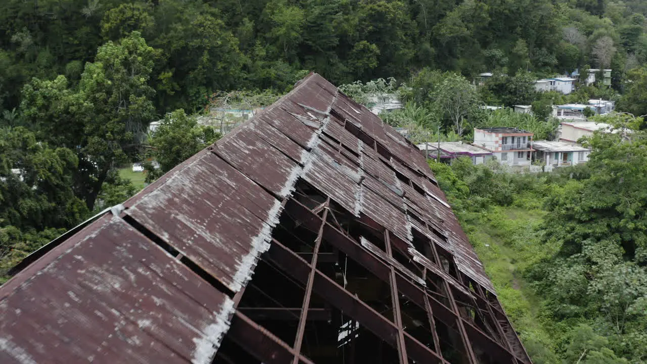 Aerial view over the rusted and partially collapsed roof of an old factory in Puerto Rico